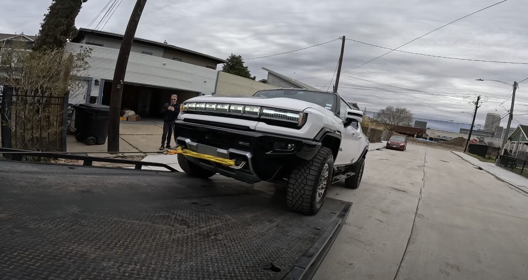 Vehicle secured on flatbed for long-distance towing
