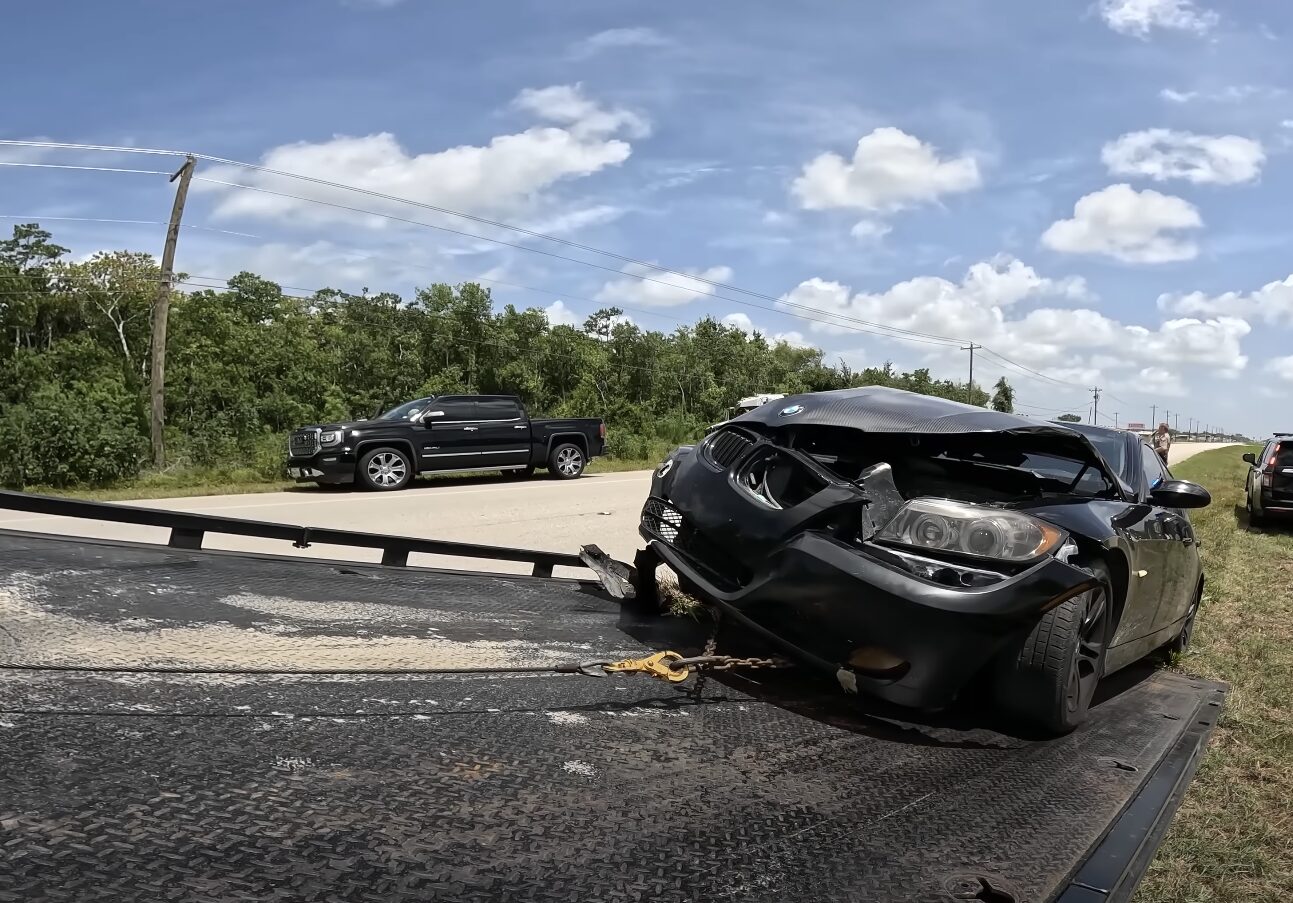 Accident recovery scene with damaged vehicle and tow truck